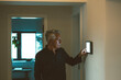 © Westend61 - Senior man with white hair using smart home app on tablet PC at home