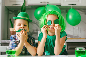 Two toddler boy and girl celebrate the holiday on March 17. Child celebrate St. Patrick's Day. Traditions, holidays concept.