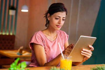 Wall Mural - Portrait og happy woman using digital tablet for work, study or social media. People technology