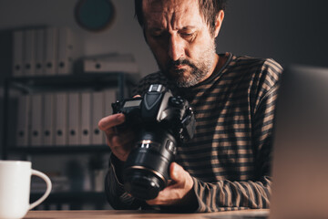 Photographer looking at DSLR camera display