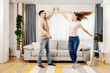 © dusanpetkovic1 - A playful couple dancing together at their new home.
