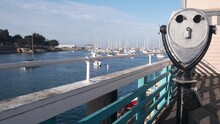 Yachts In Harbor Or Bay, Monterey Marina, Old Fishermans Wharf, Quay Or Pier, California Coast USA. Stationary Binoculars, Tower Viewer Or Telescope By Ocean Sea Water. Beachfront Waterfront Boardwalk