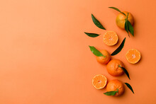 Many Fresh Ripe Mandarin With Green Leaves On Colored Background, Top View, Space For Text