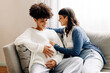 © (JLco) Julia Amaral - Female parents-to-be sitting together at home