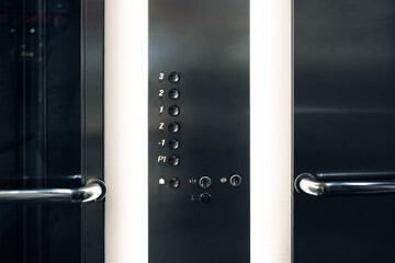 Elevator cabin, an elevator control panel with keys for floors, buttons in cabin of used elevator in business center