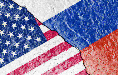 Wall Mural - the flags of the USA and Russia painted on a ruined wall and divided by a diagonal crack.