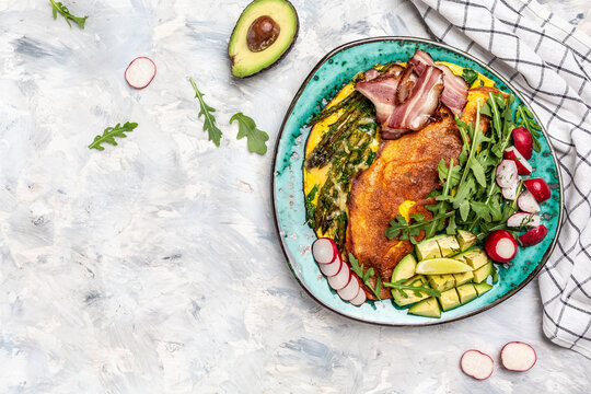 omelette asparagus, fried egg, avocado, arugula, bacon ham and cheese. Ketogenic diet. Low carb high fat breakfast. Healthy food concept. Long banner format. top view