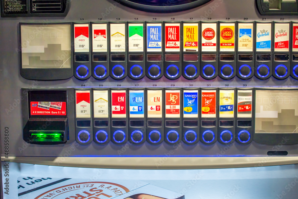 cigarette vending machine germany Leipzig, Germany - July 17, 2016: Cigarette vendor machine dispenser with  manycolors and companies signs. Stock Photo