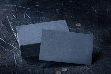 Wall Mural - Black business card mock up on a dark background, a template for design presentation, elegant visiting cards on black