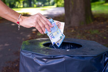 Woman Throws Away Money Banknotes, Lots Of Euros Thrown In The Public Trashbin