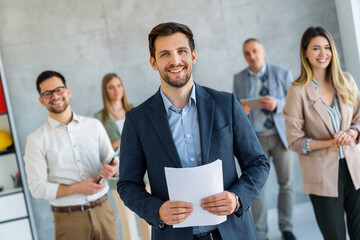 Group of business people and software developers working as a team in office