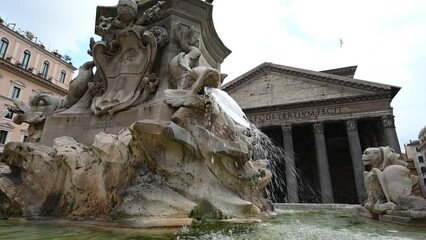 Wall Mural - Antique travertine fountain with fish sculptures on piazza Rotonda outside temple of gods Pantheon