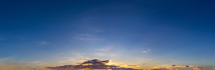 Wall Mural - panorama photo of clouds or cloudscape with dark blue sky at sunset or evening time.