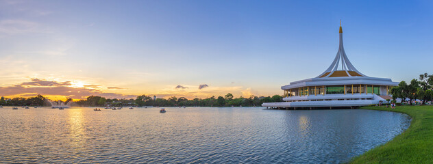 Wall Mural - Panorama photo of lake with Ratchamangkhala Pavilion at public park name Suan Luang Rama IX on sunset or evening time Bangkok, Thailand.