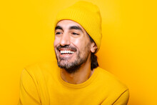 Cheerful Man Looking Away In Yellow Studio
