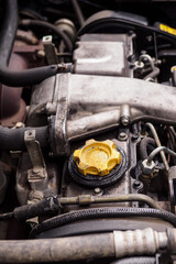 Wall Mural - Yellow cap on diesel engine with traces of oil.