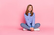 Full size photo of blond teen girl sit look promo wear pullover jeans sneakers isolated on pink background