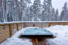 The Warm Hot Tub Invites You To Relax In The Beautiful Winter Landscape As The Snow Slowly Falls Down.