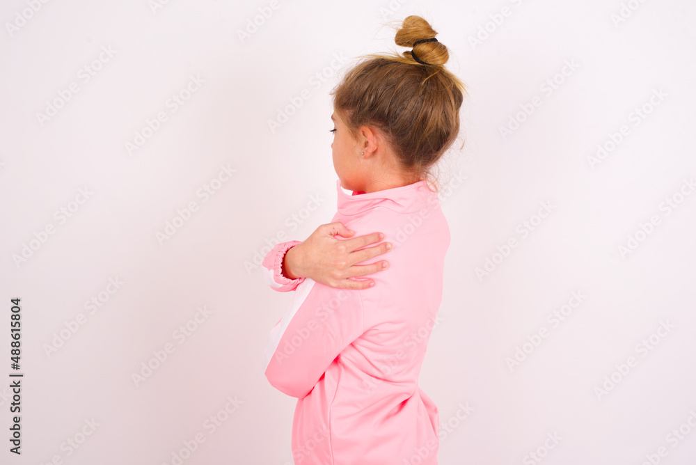 caucasian little kid girl with bun hairstyle wearing pink tracksuit ...