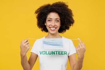 young fun woman of african american ethnicity wear white volunteer t-shirt take off sterile mask ppe