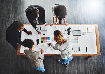 Sticker - The game plan is all set out. High angle shot of a group of businesspeople having a meeting in an office.