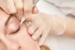© elenavolf - Permanent makeup. Beauty spa procedure. young woman. Face tattoo. Eye micropigmentation. Professional face microblading. Female cosmetology device. Copyspace. Mouth treatment. Dermatology