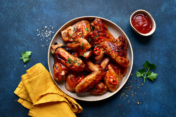 Wall Mural - Grilled spicy chicken wings with ketchup . Top view with copy space.