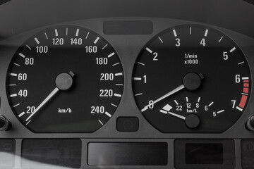 The dashboard of the car with white arrows with a speedometer, tachometer and other tools to monitor the condition of the vehicle in modern style on white isolated background