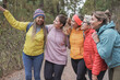 Multiracial women enjoy hiking in nature - Multi generational friends having fun during trekking day