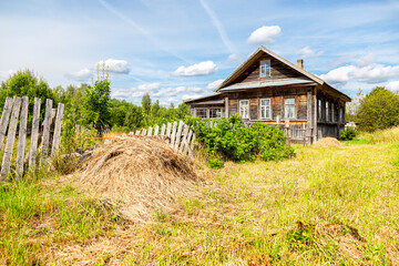 Wall Mural - Old abandoned rural wooden house in russian village in summer