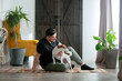 © Masson - Man sit on floor with a dog at home