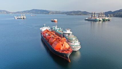 Wall Mural - Aerial drone photo of abandoned lng tanker and small cruise liner anchored in industrial Gulf of Elefsina, Attica, Greece