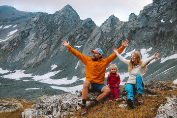 Wall Mural - Family vacations father and mother with child hikers happy raised hands enjoying mountain view travel hiking camping outdoor adventure active healthy lifestyle parents with kid