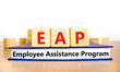EAP employee assistance program symbol. Concept words EAP employee assistance program on cubes on book on a beautiful white background. Business EAP employee assistance program concept. Copy space.