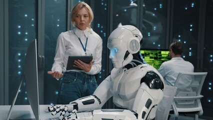 cybernetic robot worker using desktop computer programming server cooperating in data center. modern