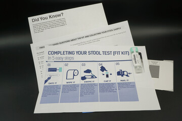 Colorectal cancer screening test kit. Isolated on black. Healthcare, prevention.