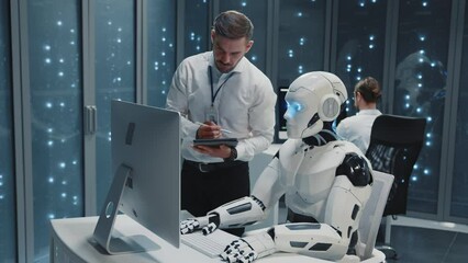 Wall Mural - future data center. caucasian it office manager talking to robot worker cooperating using computer d
