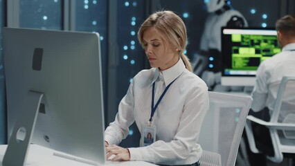 Wall Mural - high-tech data center. people and robots cooperation. young blonde female assistant working on compu