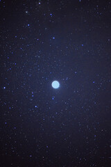 Wall Mural - Vertical of the moon and stars illuminating the dark sky