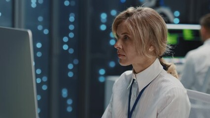 Wall Mural - blonde female it administrator using desktop computer checking server data software development in p
