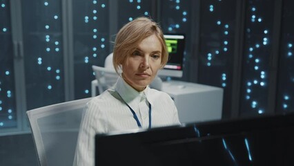 Wall Mural - blonde caucasian young smart female specialist using multiple monitor desktop computer in high-tech 