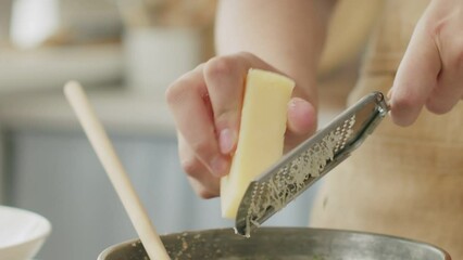 Wall Mural - Crop woman grating cheese for pasta