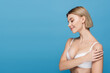 © LIGHTFIELD STUDIOS - slim young woman in white bra smiling isolated on blue