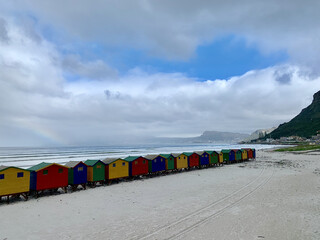 Sticker - The colorful small beach hotels at a beach during the day