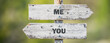 opposite signs on wooden signpost with the text quote me you engraved. Web banner format.
