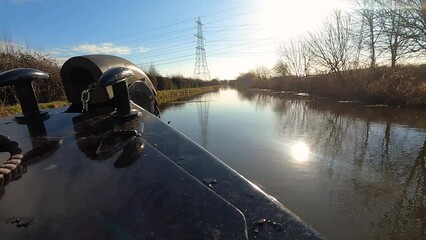 Wall Mural - View of a British canal in rural setting from bow of narrowboat