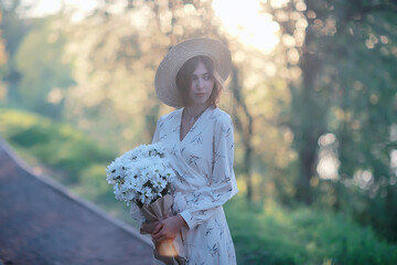Wall Mural - girl in a straw hat portrait spring freedom / concept spring view model happy people