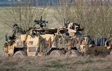 British Army Supacat Jackal 6x6 Army Rapid Assault, Fire Support And Reconnaissance Vehicle In Action On A Military Exercise, Wiltshire UK