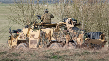 british army Supacat Jackal 6x6 army rapid assault, fire support and reconnaissance vehicle in action on a military exercise, Wiltshire UK