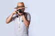 © IHERPHOTO - tourist in a hat with a camera, Happy tourist in a hat with a camera around his neck